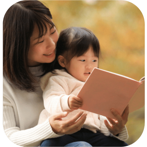 Young woman reading to her daughter